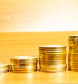 4 rows of coins arranged in ascending order with selective focus and blurred background. Growth concept.