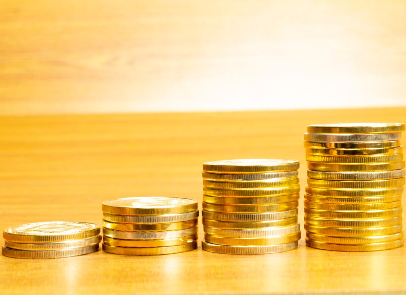 4 rows of coins arranged in ascending order with selective focus and blurred background. Growth concept.